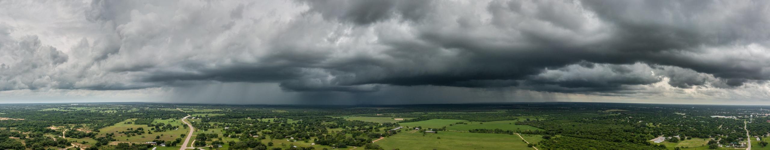 Aerial shot of land with storm clouds above